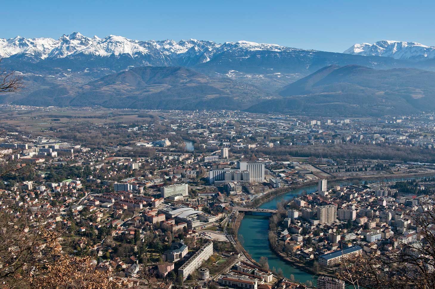 Vue aérienne du campus santé de La Tronche et du massif de Belledonne en hiver.